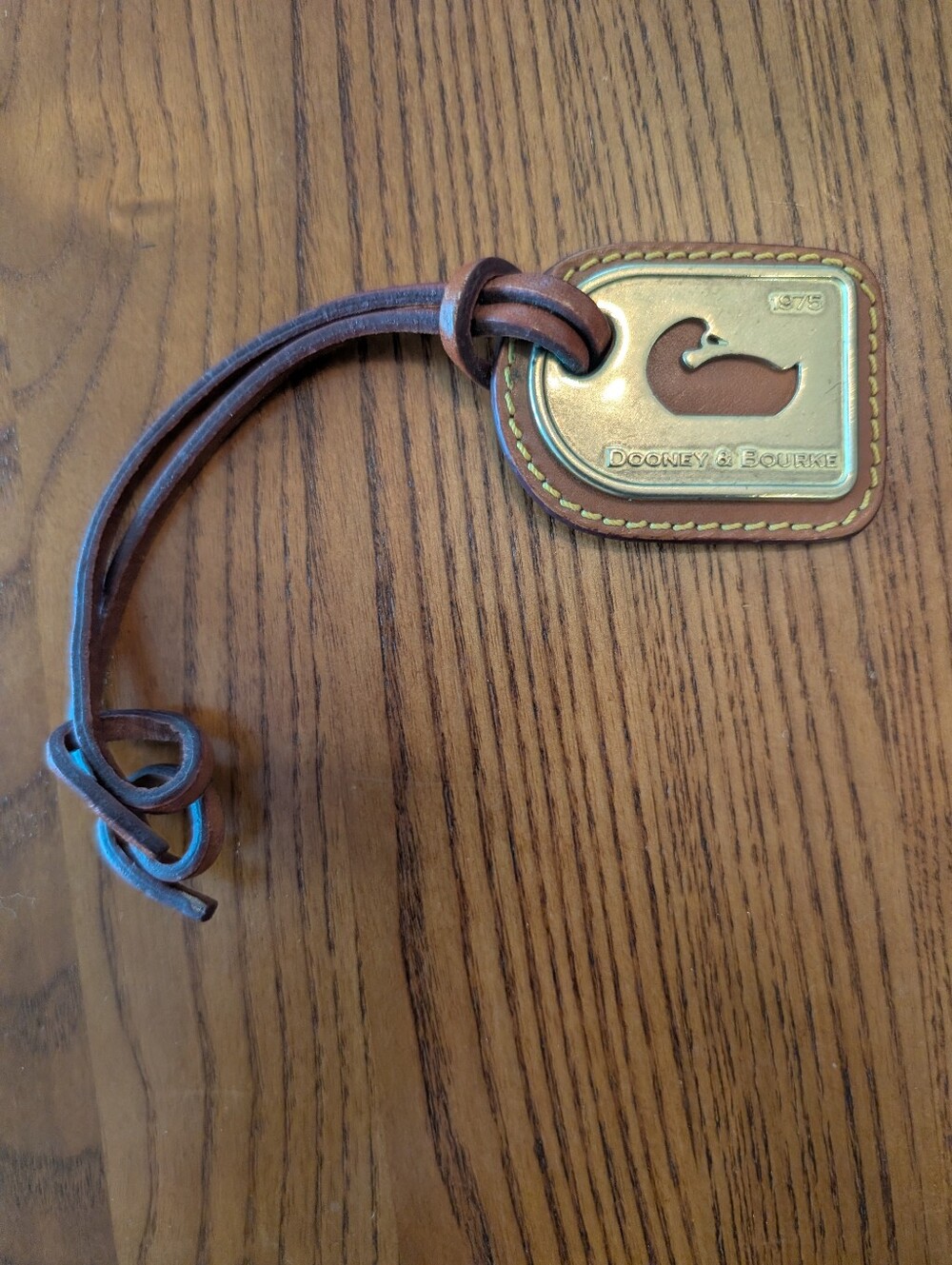Dooney & Bourke Vintage Leather Whale Tag  — Brown & Gold